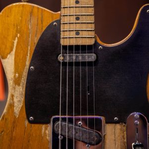 A closeup of the pick guard on one of Springsteen's Fender Telecaster electric guitars. It is quite worn from frequent use.